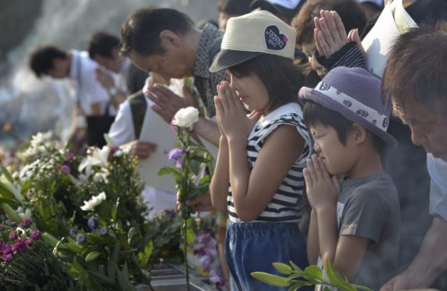 People pray at a memorial in Hiroshima, Japan, Aug. 6, to commemorate the victims of the atomic bombing of the city by the United States in 1945. (CNS photo/Paul Jeffrey)